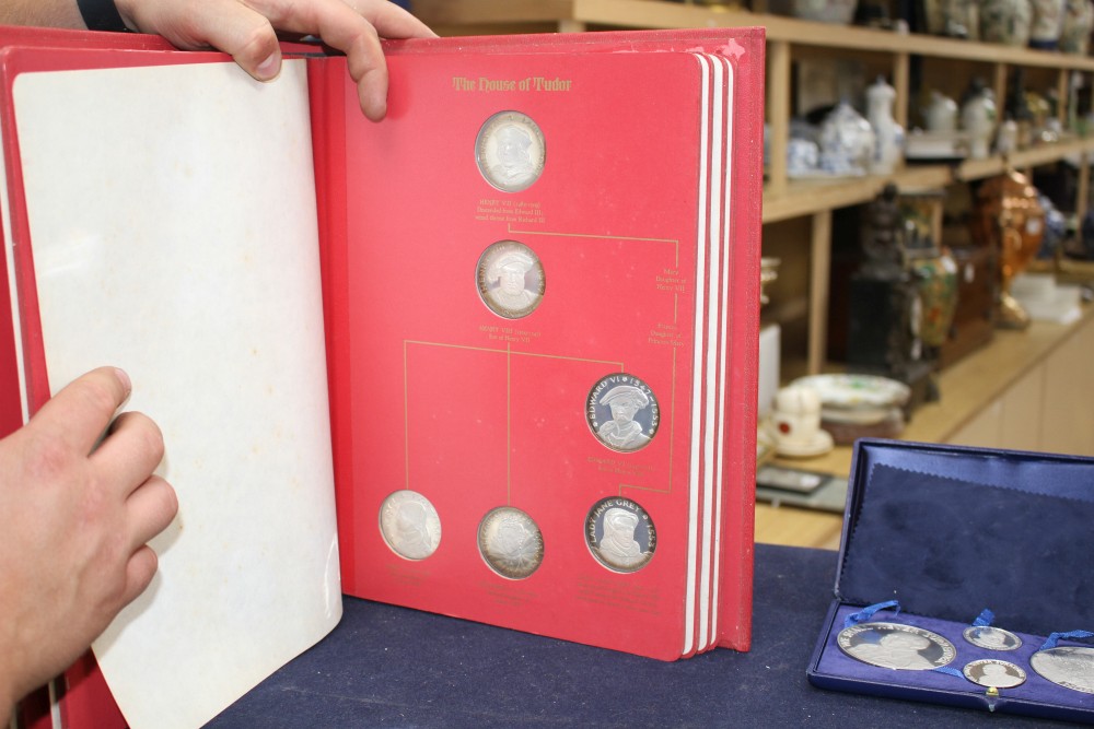 A set of the Kings and Queens of England sterling silver proof medallions, housed in original album and three other cased sets